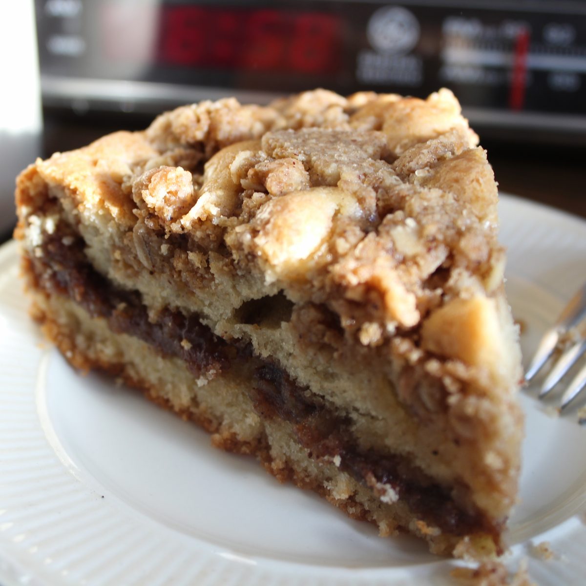 A slice of hazelnut coffee cake with cinnamon ribbon and streusel